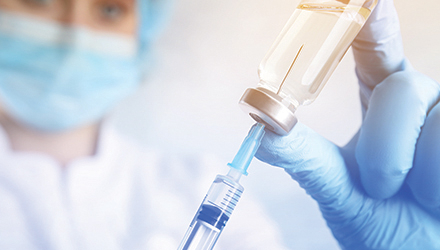 Doctor with vaccine and needle