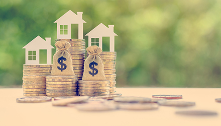 Coin stacks topped with houses
