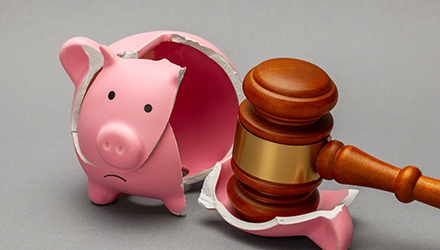 Broken piggybank and gavel