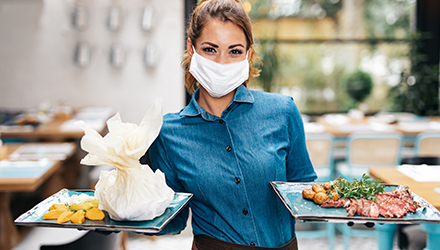Restaurant employee holding plates