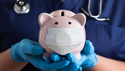 Doctor holding Piggy bank with mask