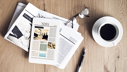 Newspaper and coffee on desk