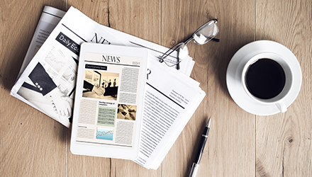 Newspaper and coffee on desk