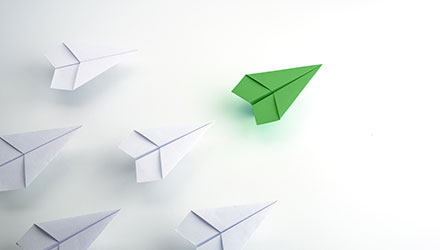 paper airplanes with one leading the pack
