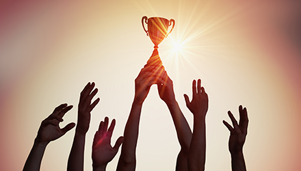 trophy with hands in air