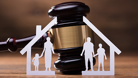 Gavel inside white lined house and family