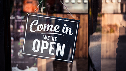 'We're Open' sign on door