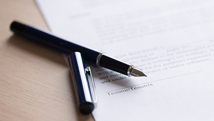 uncapped fountain pen over signature line