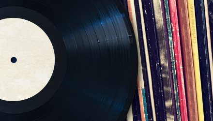 A Record Next to a Row of Record Sleeves