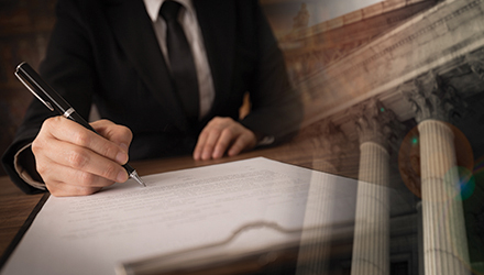 A Business Man with a Pen Signing a Contract with a Federal Building in the Background