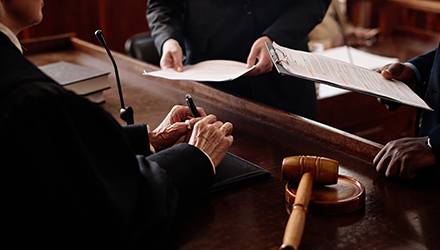 A judge on the bench listening to lawyers