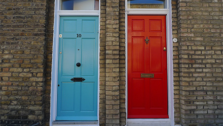 a blue door and red door to adjacent properties