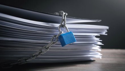 Stack of paper locked with padlock